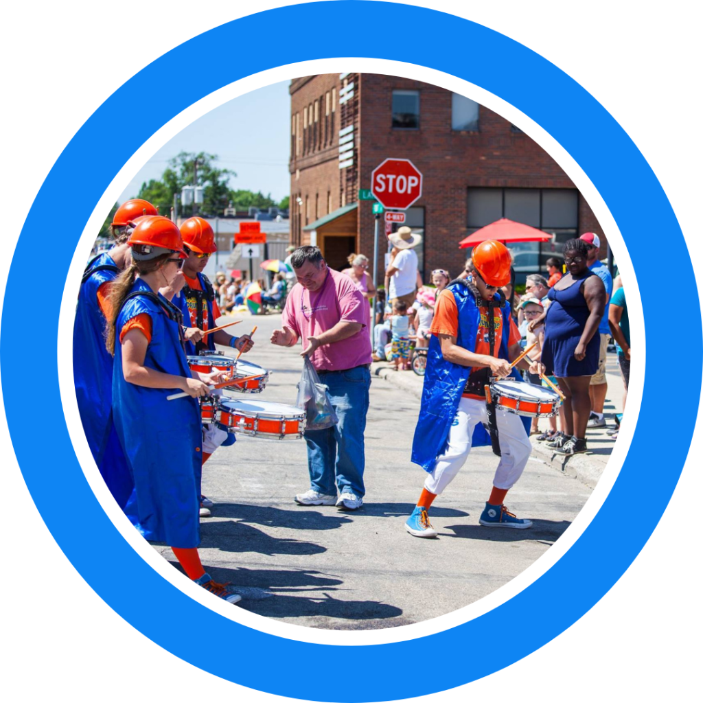 The Kracker Jacks Drumline playing at a parade for a crowd