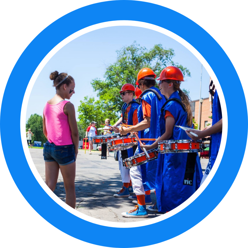 The Kracker Jacks Drumline playing for a girl at a parade