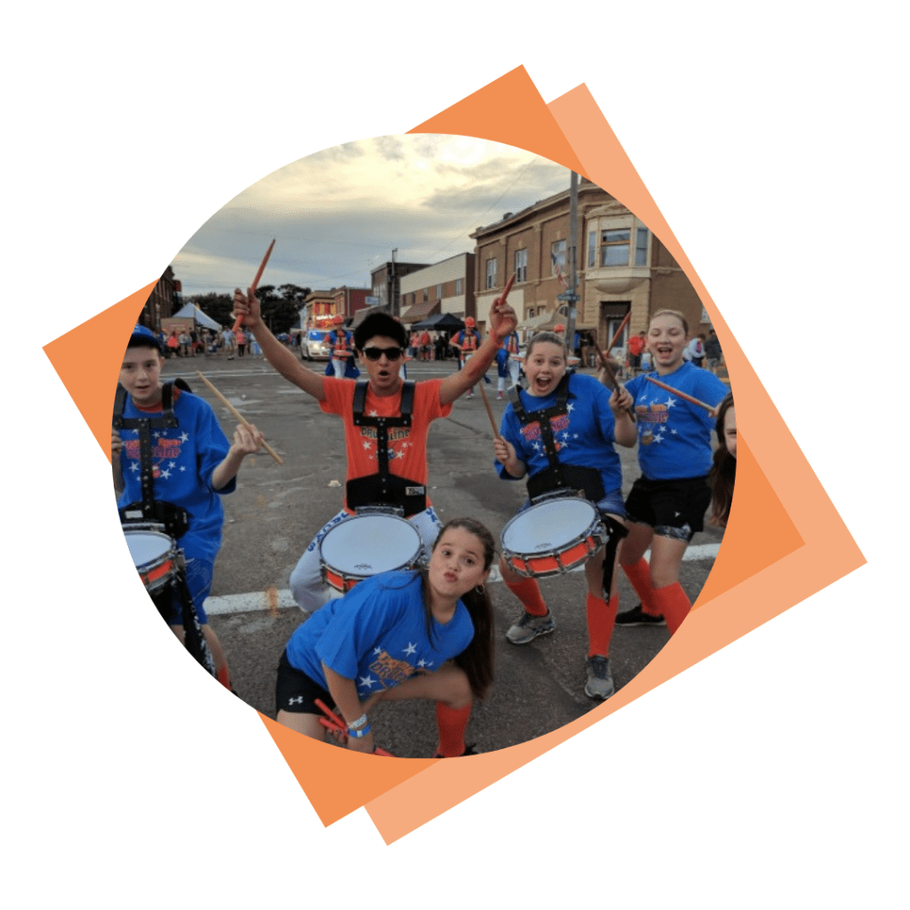 The Jr. Jacks Drumline playing at a parade.